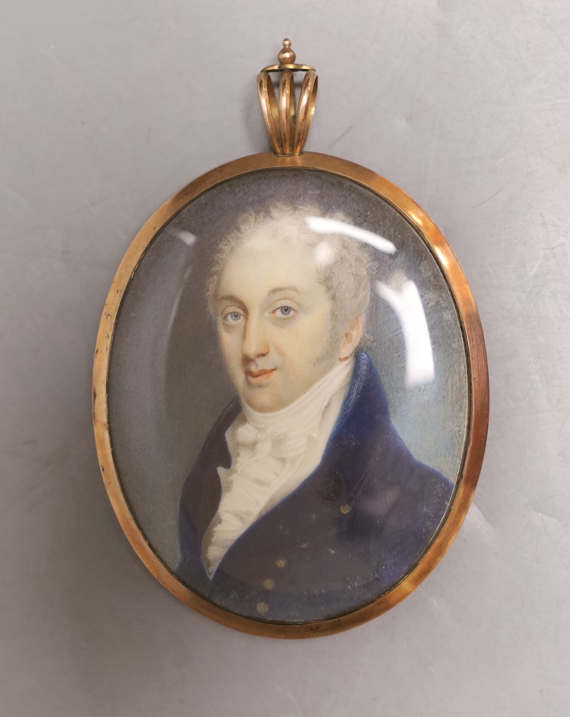 A late Georgian portrait miniature of a gentleman, with memorial hair plaque and monogram on verso.